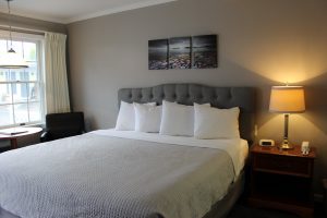 Motel Room with 1 King Bed with blue white bedspreads