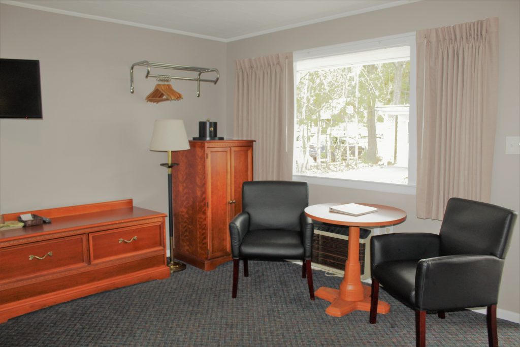 motel room with 2 chairs and round table