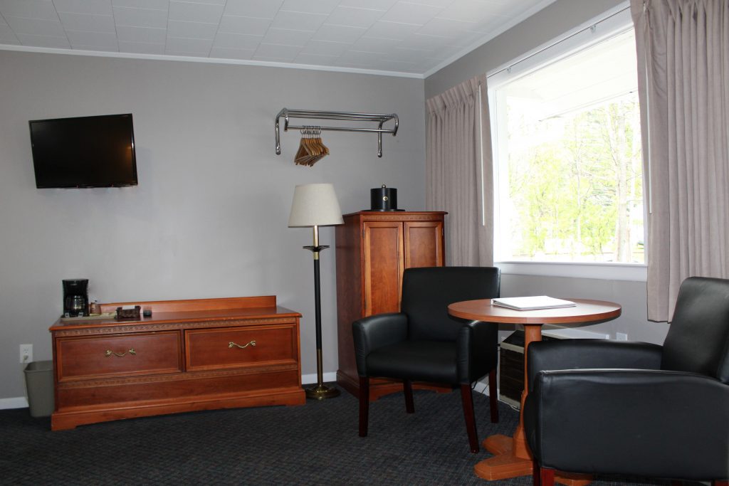 tables and chairs in motel room