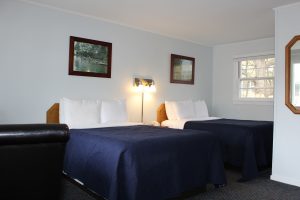 Motel Room with 2 double Beds with blue bedspreads